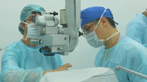 Doctors discussing over an electronic eye machine Stock Footage 77483060