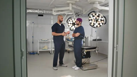 Doctors Discussing Procedure in Operating Room Stock Footage 315985156