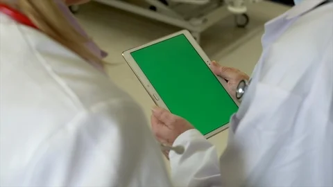 Doctors Discussing Results on Tablet OTS Stock Footage 88620839