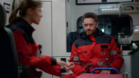 Doctors discussing work in ambulance car. Medical workers gesturing hands Stock Footage 166880841