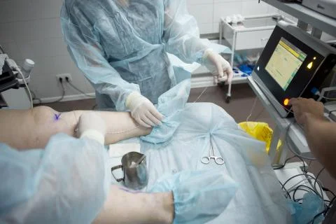 Doctors doing vein surgery procedure Stock Photos