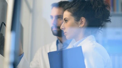 Doctors examining a patient's x-ray Stock Footage 86682672