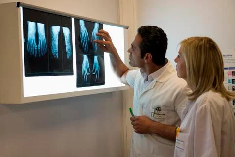 Doctors examining X-ray report in hospital Stock Photos