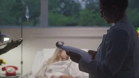 Doctors Exchanging Notes About Patient Stock Footage 211880875