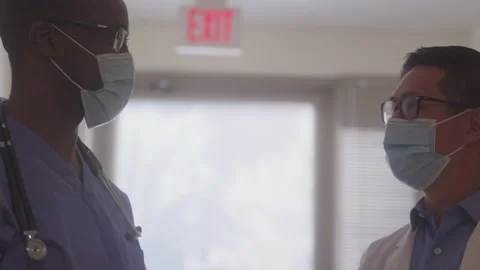 Doctors Exchanging Patient Notes Stock Footage 219591803