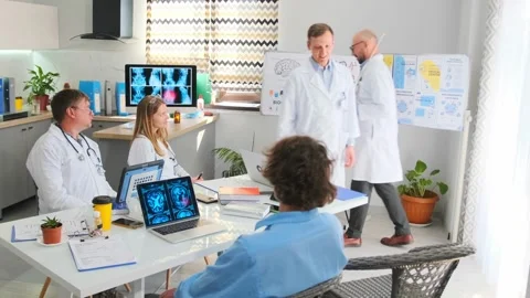 Doctors exchanging pointer during biohacking lecture and sharing opinions at Stock Footage 316293244