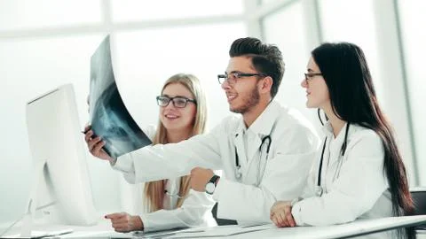 Doctors experts discuss x-ray,sitting at the table Stock Photos