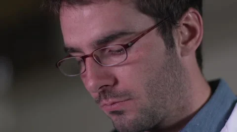 Doctor's face close up looking at iPad Video stock 55302541