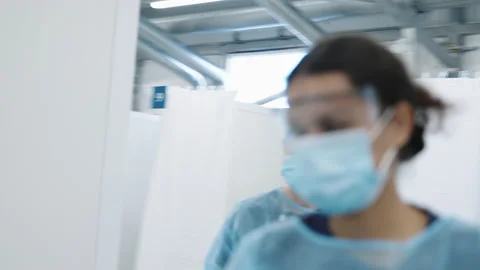 Doctors In Facemask Walking Through Hospital Video stock 149555068