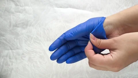 The doctors female hands take off the blue medical gloves Stock Footage 314879751