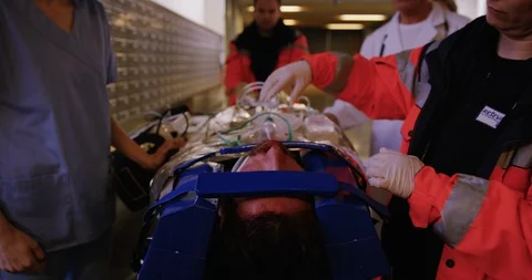 Doctors Getting Injured Man To Operating Room Stock Footage 128439292