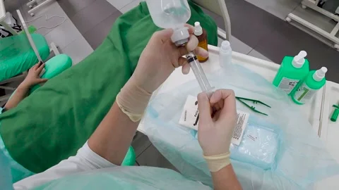 The doctor's getting the medicine in the syringes. First-person view. The Stock Footage 134942802