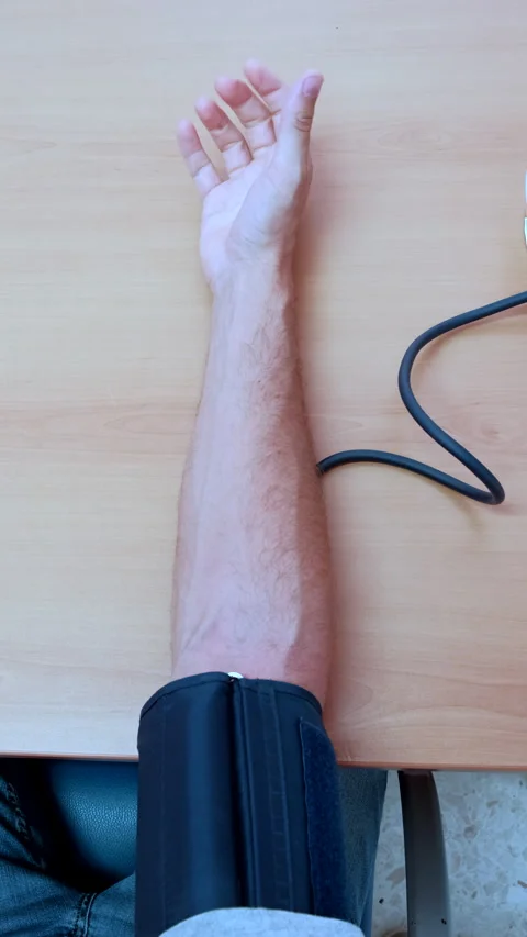 Doctor's Hand Checking Blood Pressure with Device Stock Footage 282398818