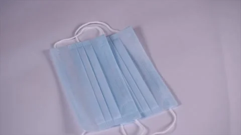 A doctor's hand counting the disposable mask and keeping them on the table Stock Footage 155668372