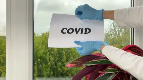 Doctor’s hand crumple sheet of paper with word Covid. Stock Footage 160486031