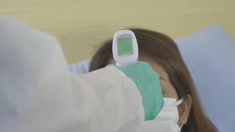 The doctor's hand in the medical gloves is using temperature meter equipment. Stock Footage 145977671