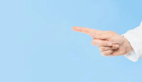 Doctors hand pointing at copy space. Blue background. Medicine Stock Photos