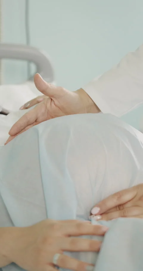 Doctors Hand on Pregnant Belly Stock Footage 320090983