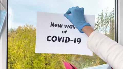 Doctor’s hand put sheet of paper with word New wave of covid-19 Stock Footage 162839174