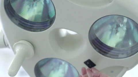 The doctor's hand switches on the lamp in the operating room Stock Footage 73287765