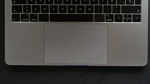 Doctor's hand taking coronavirus cure with laptop in the background Stock Footage 128708739