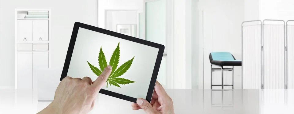 Doctor's hand touch screen of the digital tablet with the marijuana leaf symb Stock Photos