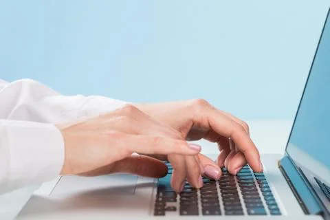 Doctor's hand is typing the data into the system. Using a laptop computer Stock Photos