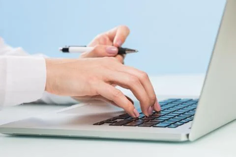 Doctor's hand is typing the data into the system. Using a laptop computer Stock Photos