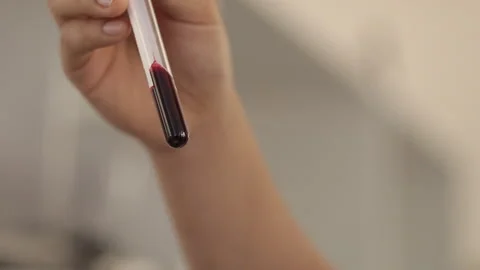 Doctor's hand working in a testing laboratory drawing blood samples Video stock 263461992