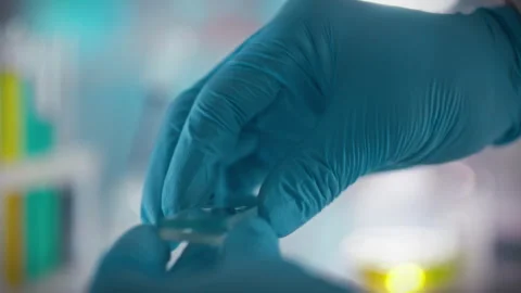 A doctors hands carefully conduct a blood test in a sterile laboratory holdi Stock Footage 331452004
