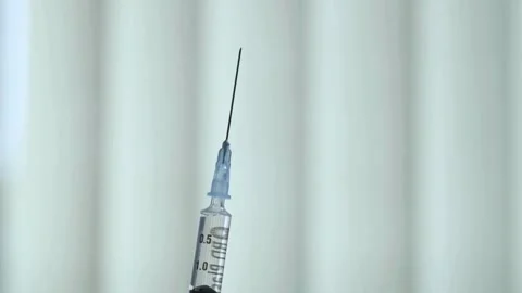 Doctor's hands close-up with Flu Shot Vaccine Vial Dose Hypodermic. Female 스톡 동영상 336587345