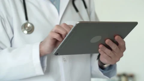 Doctors hands diagnosis and typing on tablet computer Stock Footage 170033253