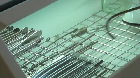 Doctor's hands in gloves putting tool into sterilizer machine in the hospital Video stock 101399969
