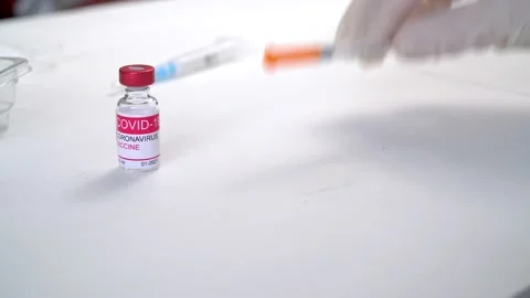 Doctors hands in gloves take vials with coronavirus vaccine and syringe Stock Footage 153932886