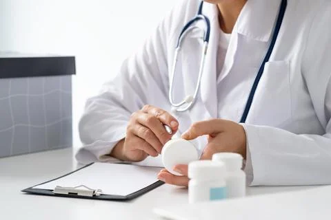 Doctor's hands hold the composition on a jar of pills, the concept of nutri.. Stock Photos