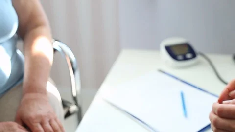 Doctor's hands hold the hands of an old woman as a sign of support. Stock Footage 118447904