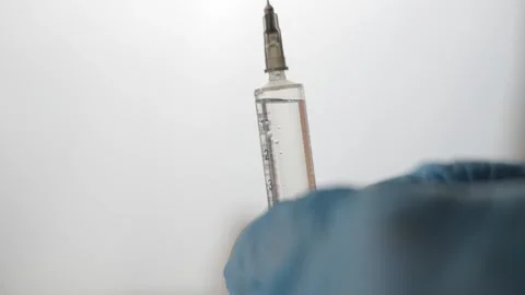 Doctor's hands hold a syringe. 스톡 동영상 262714105