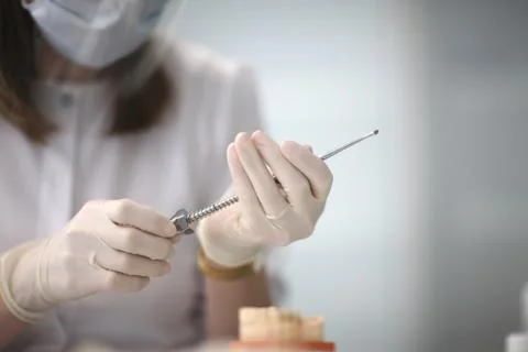 Doctor's hands with the instrument in the operating room of the dental clinic Stock Photos