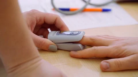 The doctor's hands measure the oxygen level in the patient's blood before being Stock Footage 151780351