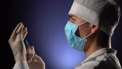 The doctor's hands in medical gloves gaining in a syringe medication Stock Footage 126270953