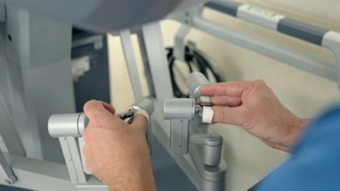 Doctor's hands move slowly the handles of robotic equipment. Stock Footage 212422309