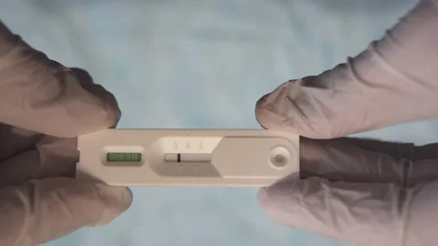 Doctor's hands with a negative covid-19 antigen pcr cassette. Stock Footage 164232381