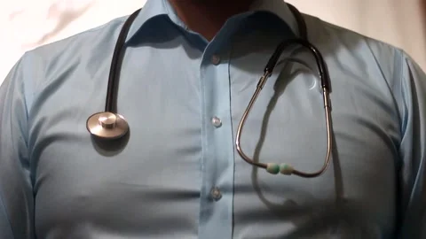 The doctor's hands place a stethoscope on the neck Stock Footage 321370969