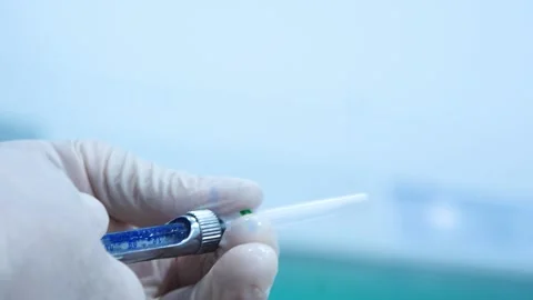 The doctor's hands prepare the syringe for injection. Stock Footage 145602677