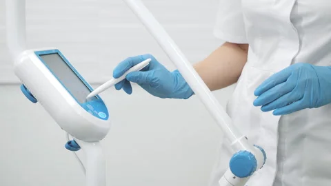 Doctors hands in protective gloves adjusting modern medical device. Stock Footage 317172852