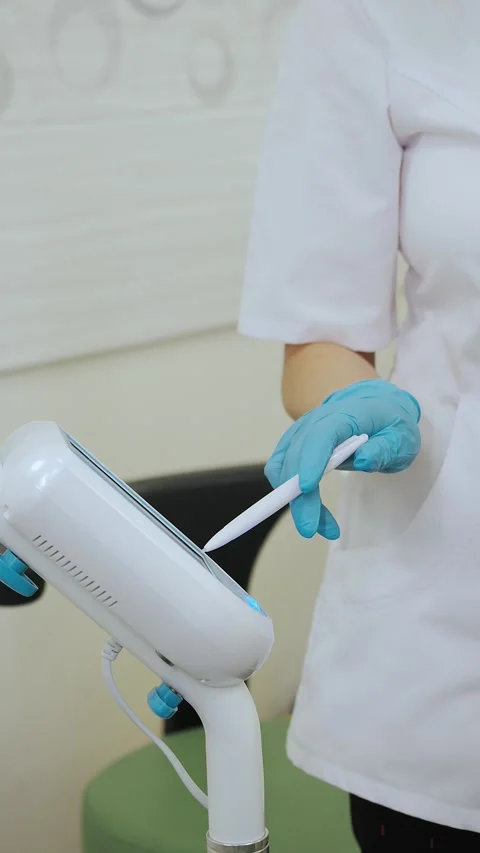 Doctors hands in protective gloves adjusting modern medical device. Stock Footage 317797364