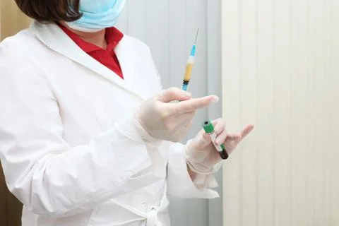 Doctor's hands with a syringe for plasmolifting Stock Photos