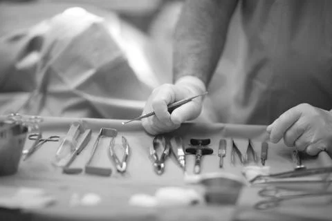 Doctor's hands on the table with the tool in the operating room dental clinic Stock Photos