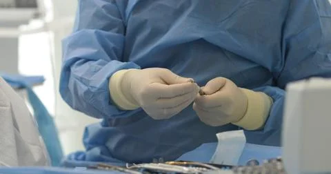 Doctor's hands with a working tool. Preparation and process of dental treat.. Stock Photos
