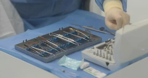 Doctor's hands with a working tool. Preparation and process of dental treat.. Stock Photos